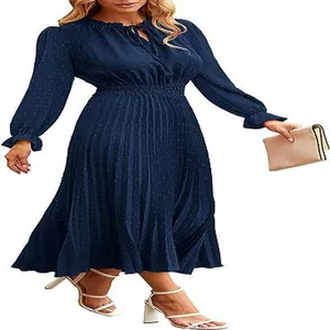 Detail of navy Swiss dot pleated dress with long sleeves and elastic waist