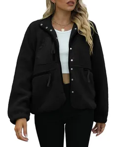 Detail of women's black sherpa fleece jacket with front zipper and pockets.