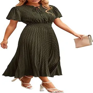 Detailed view of women's dark green Swiss dot midi dress featuring pleated skirt and waist.