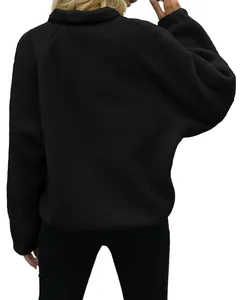 Detailed back view of a cozy women's black polar fleece jacket with soft sherpa texture for winter
