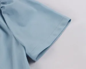 Detailed close-up of light blue dress sleeve showing high-quality stitching texture