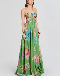 Full view of an elegant green floral print backless maxi dress for resort and vacation wear
