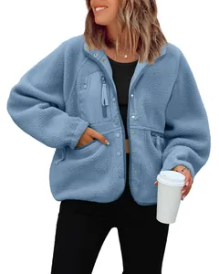 Detailed view of women's blue sherpa fleece jacket with front pockets and zipper