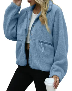 Close-up of light blue fuzzy fleece jacket showing texture and zipper pocket details.