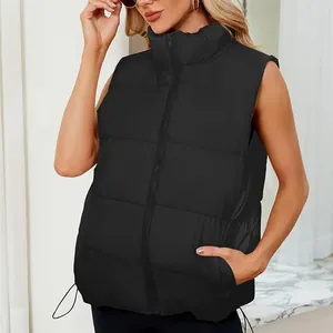 Close-up detail of women's black puffer vest showing stand collar and quilted texture.