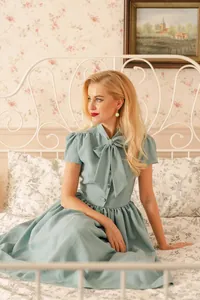 Vintage style light blue bow-tie dress with large swing skirt shown in room setting