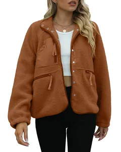 Detail shot of women's brown fleece jacket with high collar and zipper pockets