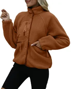 Close-up of women's brown sherpa fleece jacket with chest pocket and stand collar