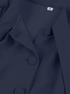Close-up of fabric texture and buttons on a navy blue dress