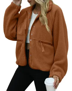 Close-up view of brown fleece jacket showing fuzzy texture and zip pockets