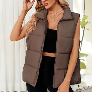 Detail of women's brown sleeveless puffer vest with a stand collar for winter.