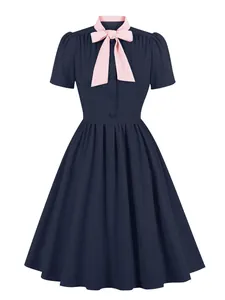 Vintage navy blue flare dress with a contrasting pink bow collar and button details