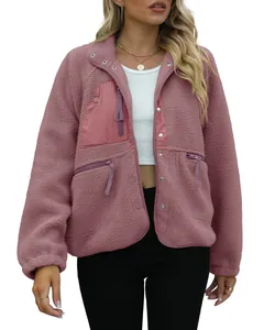 Front view of a women's dusty rose fleece jacket featuring snap buttons and zippers