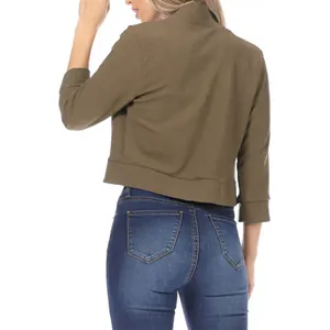 Vue arrière d'un élégant blazer court vert olive associé à un jean slim bleu foncé classique