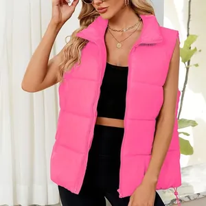 Detailed macro view of bright pink padded puffer vest with stand collar on model