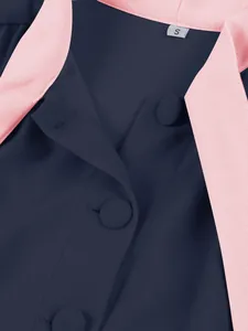 Detailed view of elegant navy blue dress featuring pink lapels and covered buttons