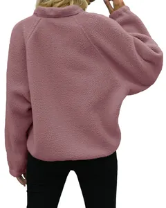 Back view of woman in dusty rose sherpa fleece pullover on white background.