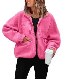Detailed close-up of women's bright pink polar fleece jacket featuring zippered pockets