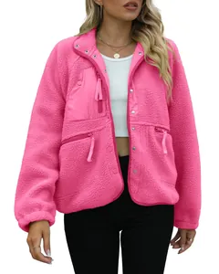 Detail view of pink sherpa fleece jacket with zipper pockets and snap buttons