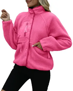 Detail view of hot pink women's fleece jacket with zipper pockets and stand collar