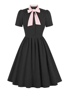 Vintage black A-line dress featuring a contrasting pink pussy-bow collar detail