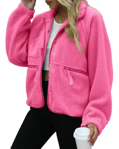Close-up of women's vibrant pink sherpa fleece jacket with zip and button detail.
