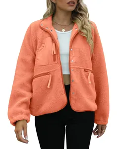 Front view of stylish women's orange sherpa fleece jacket featuring multiple functional zip pockets