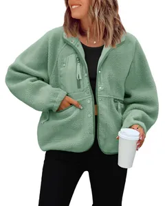 Detailed view of women's mint green fleece jacket featuring pockets and zip closure