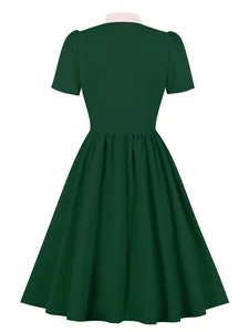 Back view of a retro dark green A-line dress with a contrast pink collar detail