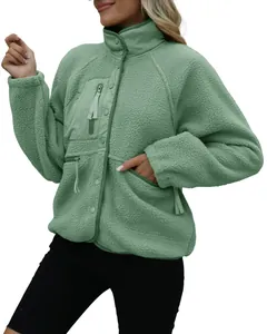 Detailed view of women's sage green sherpa fleece jacket with stand collar and zipper pocket