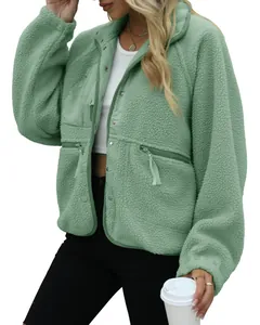 Detail view of women's mint green fleece jacket showing soft texture and pocket zippers