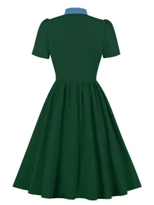 Back view of a dark green vintage A-line dress with a blue collar and short sleeves.
