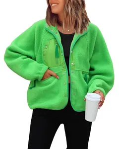 Detail view of the vibrant green women's polar fleece jacket with functional pockets.