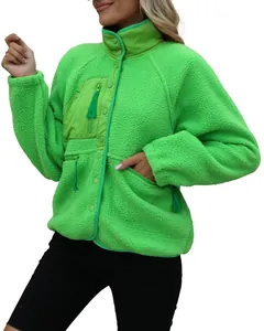 Detailed view of bright green women's warm fleece jacket with functional zipper pockets