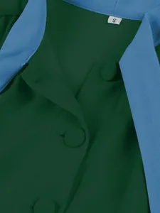 Close-up detail of a green dress featuring a blue collar and matching fabric buttons.