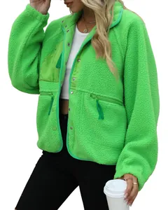 Detail of women's bright green sherpa fleece jacket with zipper pockets and snaps