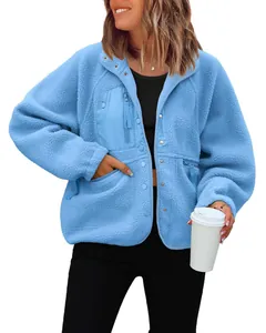 Detail view of a cozy light blue polar fleece jacket with functional pockets
