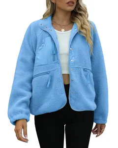 Detail of women's light blue sherpa fleece jacket with zip pockets.
