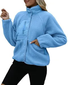 Detailed view of blue women's sherpa fleece jacket with button and pocket features.