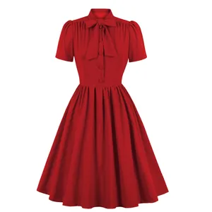 Elegant red vintage dress featuring a bow tie neck, puff sleeves, and a flared skirt
