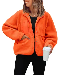 Close-up of vibrant orange fleece jacket with zipper pockets and button details