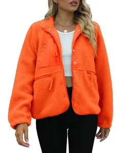 Detailed view of women's bright orange polar fleece jacket with functional zip pockets