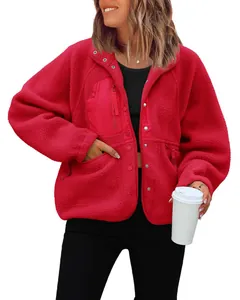 Close-up of women's red fleece sherpa jacket featuring functional chest pocket and snap closure.