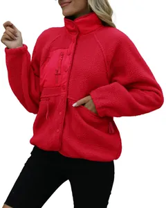 Macro view of red women's polar fleece jacket with stand collar and snap closure