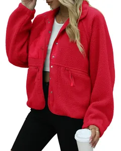 Detailed close-up of a cozy red fleece jacket for women featuring zipper pockets and snap buttons