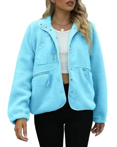 Model wearing a light blue fuzzy teddy fleece jacket with zipper pockets for winter