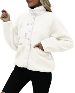 Detailed view of women's warm white fluffy fleece jacket featuring button closure