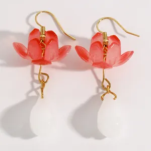 Close-up of red and white multi-layered ice flower petal earrings with white drops