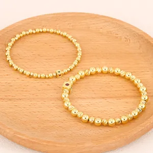 Close-up of retro handmade gold beaded stretch bracelets with tourmaline charms