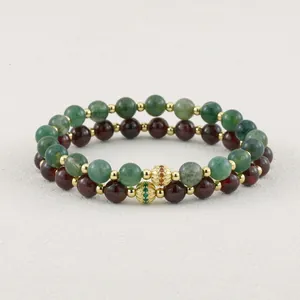 Detailed macro shot of vintage handmade green and red tourmaline beaded elastic bracelets.